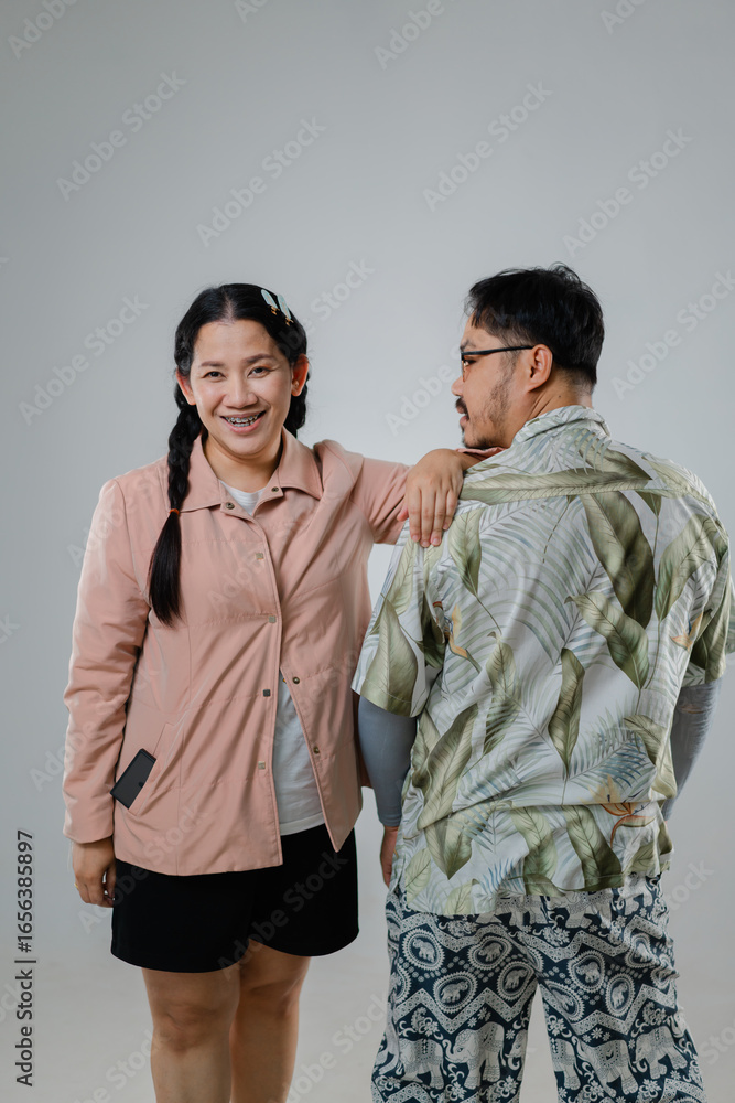 Cheerful Young Woman and Thoughtful Older Man Posing Together in Light Gray Background, Showcasing Modern Fashion and Joyful Expression Cheerful Young Woman and Thoughtful Older Man Posing Together in Light Gray Background, Showcasing Modern Fashion and Joyful Expression