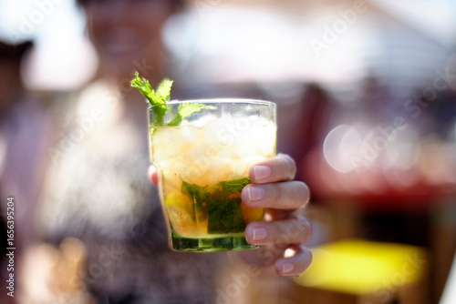 Woman's hand holding a mojito