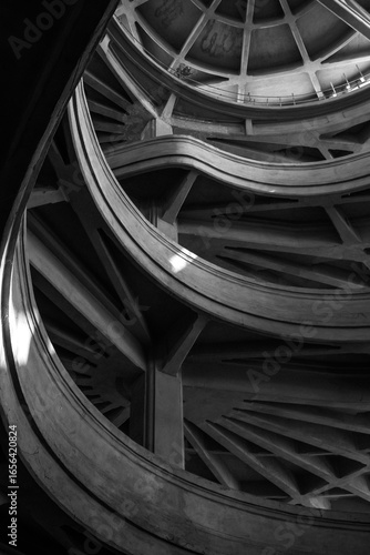 Monochrome image showcasing intricate curves and geometric design of a modern concrete structure.