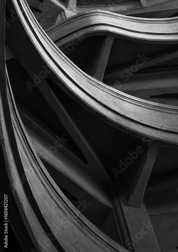 Monochrome abstract photograph featuring curved lines of architectural details from a close perspective.