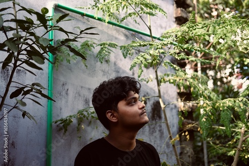 Portrait of a young man in a rooftop garden