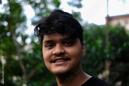 Smiling young asian boy close outdoor portrait