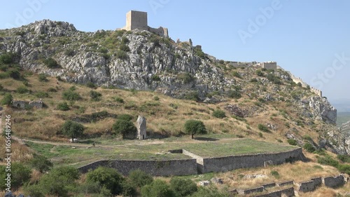 The remains of temples and structures at the top of Acrocorinth, with a view over the plains of Corinth.