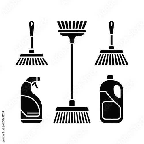 Collection of cleaning tools including brooms and cleaning product bottles