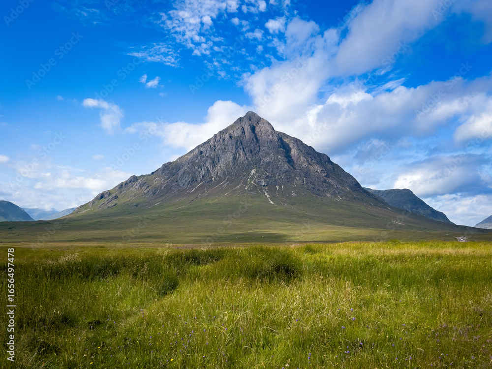 Fototapeta premium Solitary Mountain Peak Beneath a Clear Blue Sky