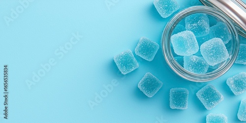 Clear blue creatine gummies in jar on flatlay background  