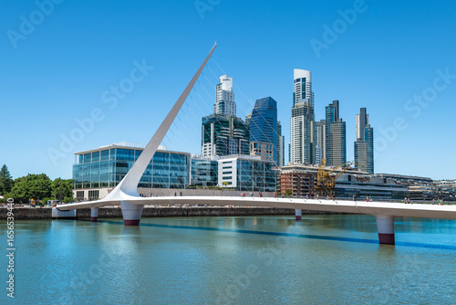 View of Puerto Madero District with Bridge over Calm Water with Blue Sky in Buenos Aires, Argentina