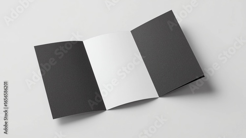 Tri-fold brochure mockup with two black outer panels and one open white inner panel, displayed on a flat surface 