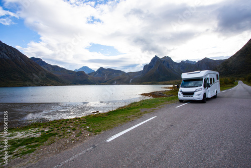 Camper van parked on the side of a road with a beautiful mountain view in bodalen, norway, on a rainy autumn day