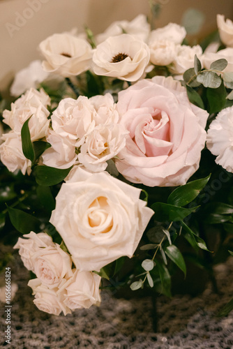 Beautiful arrangement of fresh white and pink roses with greenery in a cozy setting for a special occasion