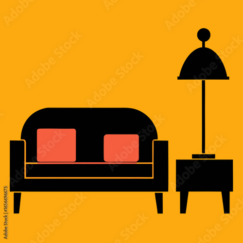 Black sofa with coral cushions beside table and lamp
