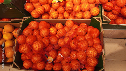 Close up photo of fresh fruits arrange neatly grocery store mandarins in box background horizontal hd high resolution image poster banner background perfect for campaigns