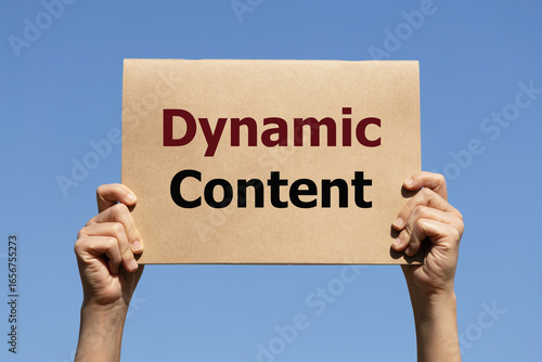 Dynamic content text on paper holding by a woman's hand with blue sky background