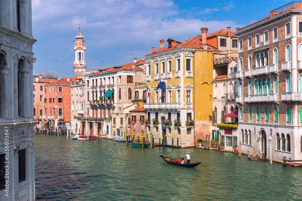 Obraz premium Traditional Venetian canal house with balconies and moored boat on Grand Canal in Venice Italy