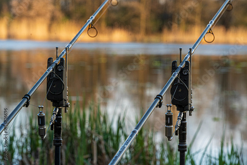 Lakeside with fishing gear and calm water reflection
