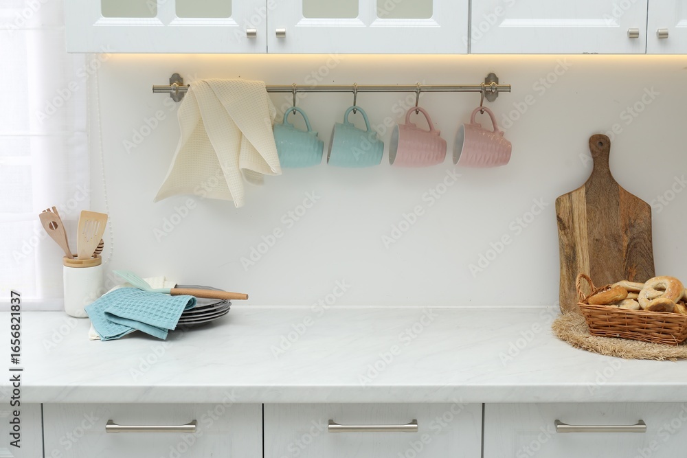 Obraz premium Clean dishware, waffle towels and pretzels on countertop in kitchen