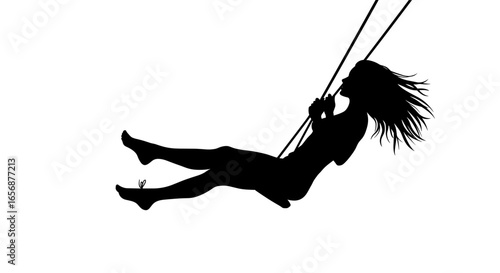 Silhouette of a woman with long hair swinging happily on a rope swing with a bright plain setting