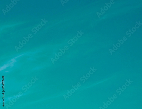Transformative Teal cloudy sky toned background. 2026 color of the year concept. 
