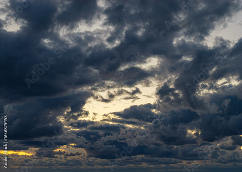 Dramatic clody evening sky with colored sunset line