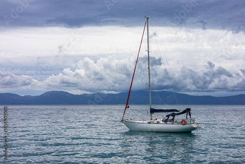 Fototapeta Naklejka Na Ścianę i Meble -  Sailboat off the coast with dramatic clouds in the background. Adriatic Sea, Croatia