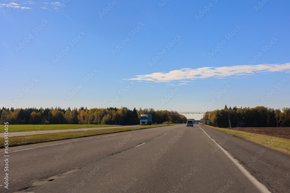 Naklejka premium Autumn landscape, road and highway, asphalt and roadside.