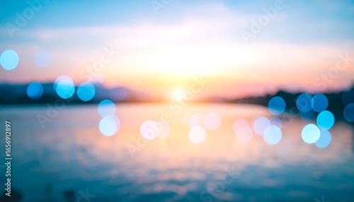 A soft-focus view of a serene sunrise or sunset over water, featuring vibrant bokeh circles of light.