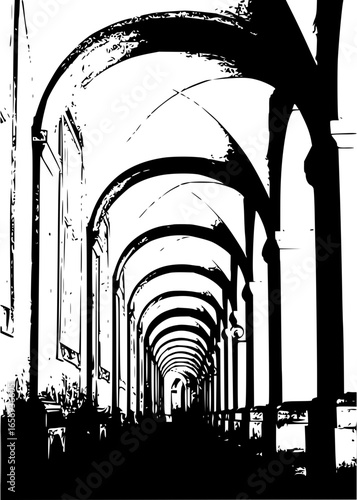 A monochrome image depicting a long corridor with arches in a building with tall pillars and shadows