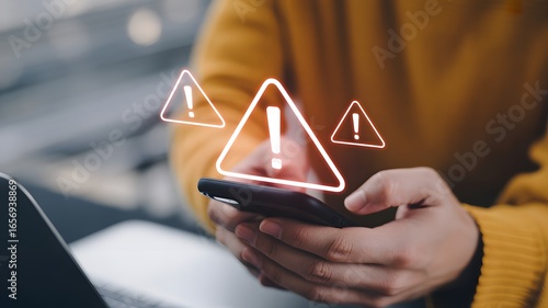 Digital Warning: A person in yellow sweater closely looks at a smart phone displaying an array of illuminated alert symbols. conveying a sense of technological anxiety or potential online threat.