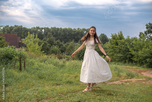 Wallpaper Mural Portrait of a young beautiful dark-haired girl in a summer dress in the park in summer. Torontodigital.ca