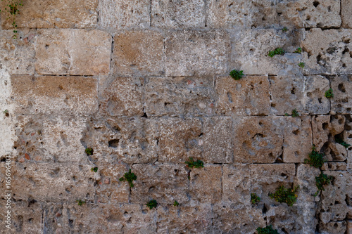 background in the form of a stone wall made of large sand blocks