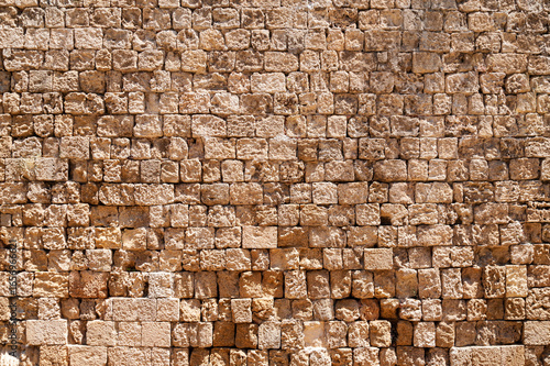 background in the form of a huge stone wall made of large sand blocks