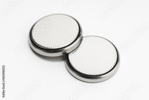 Button cell battery or coin cell isolated on white background