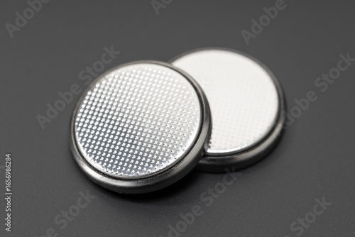 Button cell battery or coin cell isolated on black background