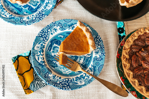 Homemade pecan and pumpkin pie desserts served at holiday dinner table