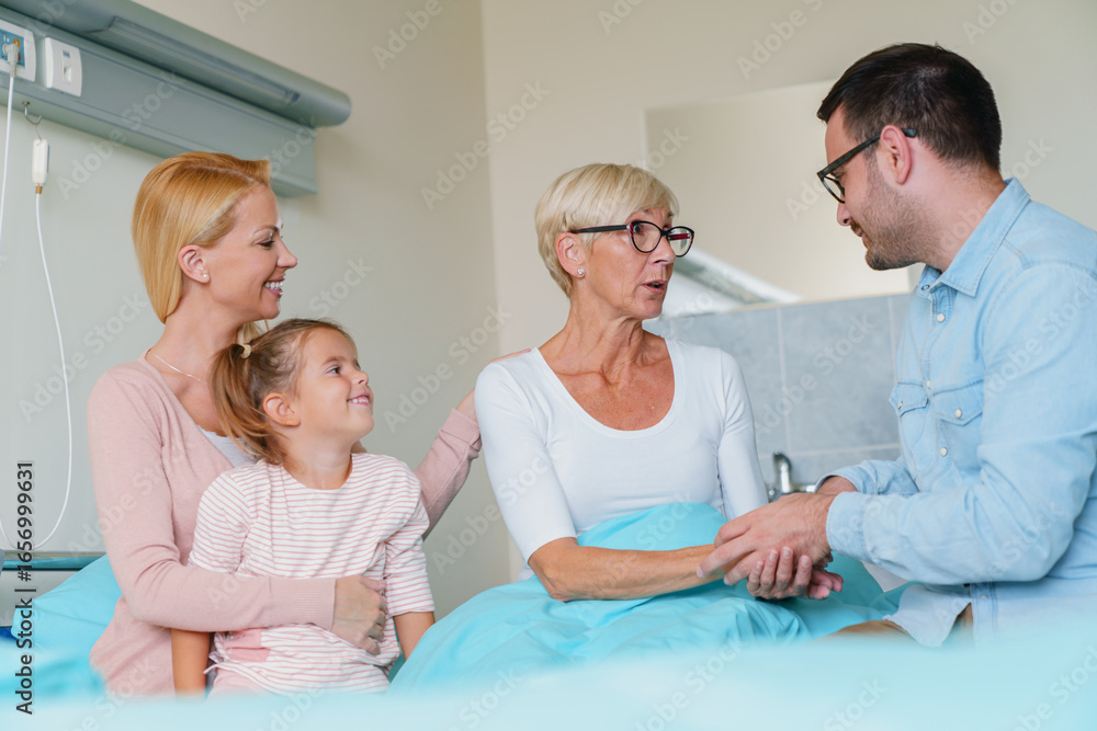 Obraz premium Multi-generational Family Gathering Around Hospital Bed Supporting Senior Woman During Medical Recovery