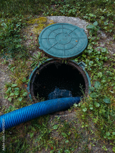 Process of cleaning up sewage collector. Pumping out household septic tank