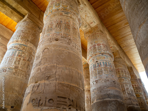 The Great Hypostyle Hall of Karnak Temple, showcasing rows of massive columns intricately decorated with hieroglyphs and reliefs