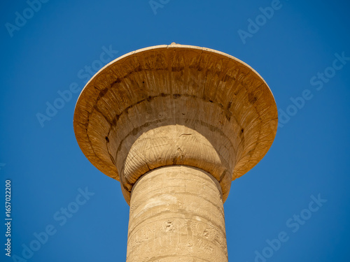 The Great Hypostyle Hall of Karnak Temple, showcasing rows of massive columns intricately decorated with hieroglyphs and reliefs