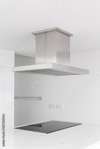 Cooker hood and electric stove of a modern and minimalist kitchen