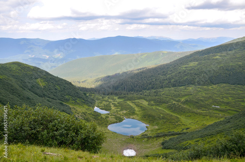Принти на полотні Tranquil beauty of mountain view with pristine Vorozheska lake nestled within vibrant green landscapes, embodying peacefulness and the magnificence of nature's charm