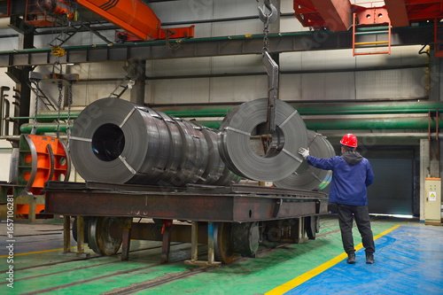 Workers on the production line of the strip steel coil factory are working