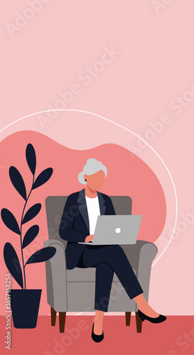 An elegant senior woman works remotely on her laptop from a comfortable armchair, embodying digital literacy and an active senior lifestyle.