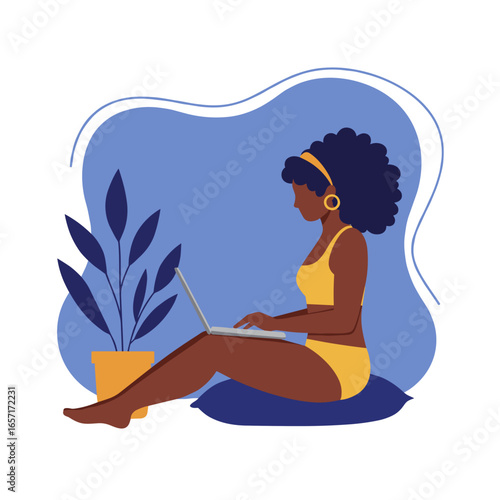Relaxed Black woman working on laptop from home, embodying remote work, freelancing, and digital connectivity in a comfortable setting.