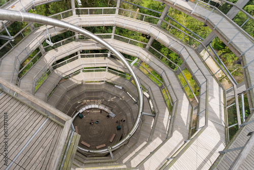 A spiral staircase with a wooden floor and a metal railing
