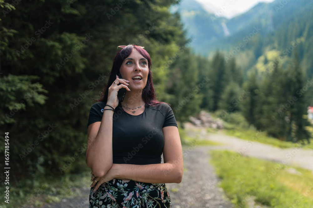 Tourist talking on smartphone enjoying mountain scenery in transfagarasan Tourist talking on smartphone enjoying mountain scenery in transfagarasan