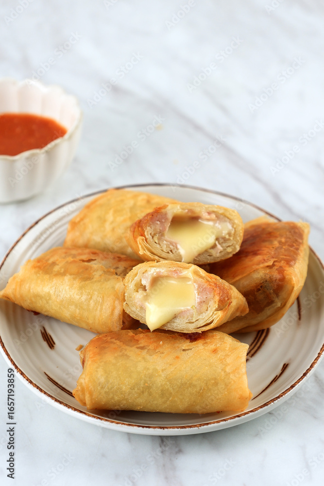 Dimsum Goreng Keju, Fried Dim Sum Filled with Melted Cheese Wrap in Spring Roll Skin. Dimsum Goreng Keju, Fried Dim Sum Filled with Melted Cheese Wrap in Spring Roll Skin.