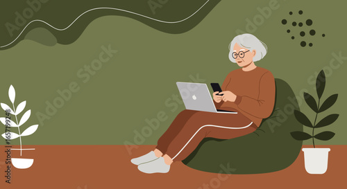 Senior woman comfortably using laptop and smartphone at home. Modern digital lifestyle, remote work, and connectivity for older adults.