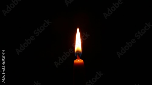 Burning candle flame and then person blowing out the candle on dark black background in holiday celebration. Candle fire flame with copy space. Magic ritual with one candle fire