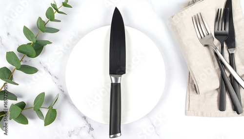 Wallpaper Mural Empty white plate with knife and utensils on marble surface. Torontodigital.ca