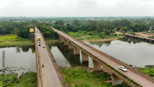 Canvas Print Aerial view of highway bridge over river, drone shot of road bridge in india, vehicles crossing river bridge, transportation infrastructure over water stock photo